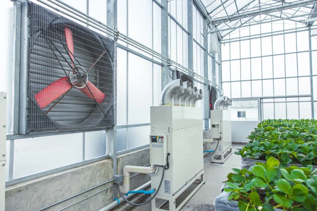 Greenhouse climate control with ventilation fan and air handling unit
