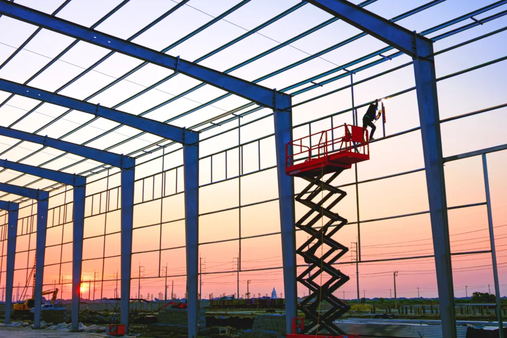 Greenhouse steel frame under construction at sunset