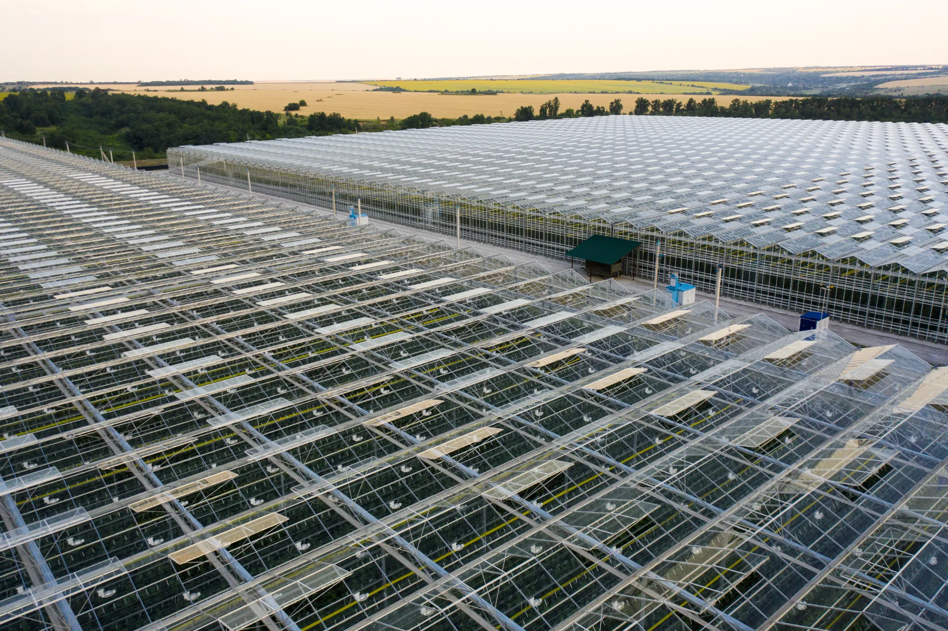 Aerial view of a large greenhouse in a rural setting